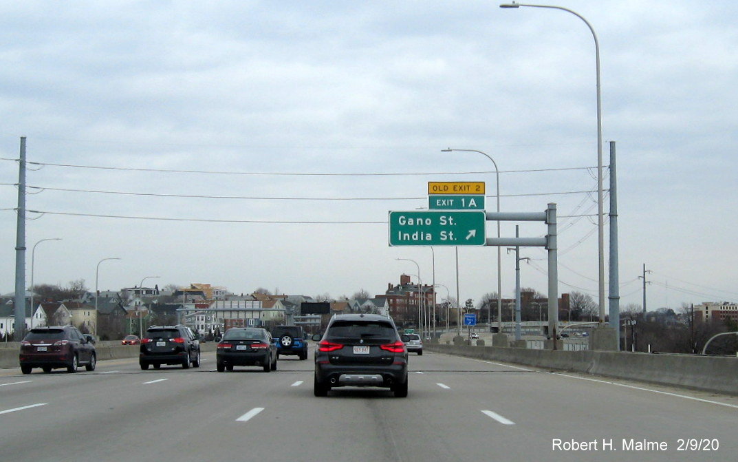 Image of overhead ramp sign for Gano Street exit with new milepost based number and yellow old exit number tab on I-195 East in Providence