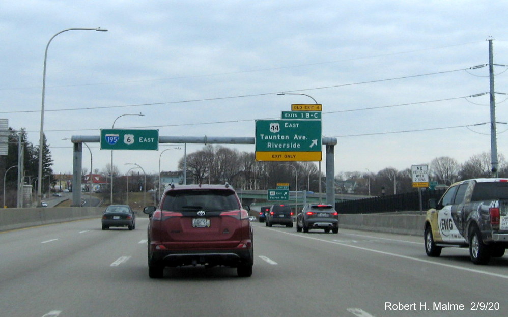 Image of overhead ramp sign for US 44 exits with new milepost based exit numbers and yellow former exit tab on I-195 East in East Providence