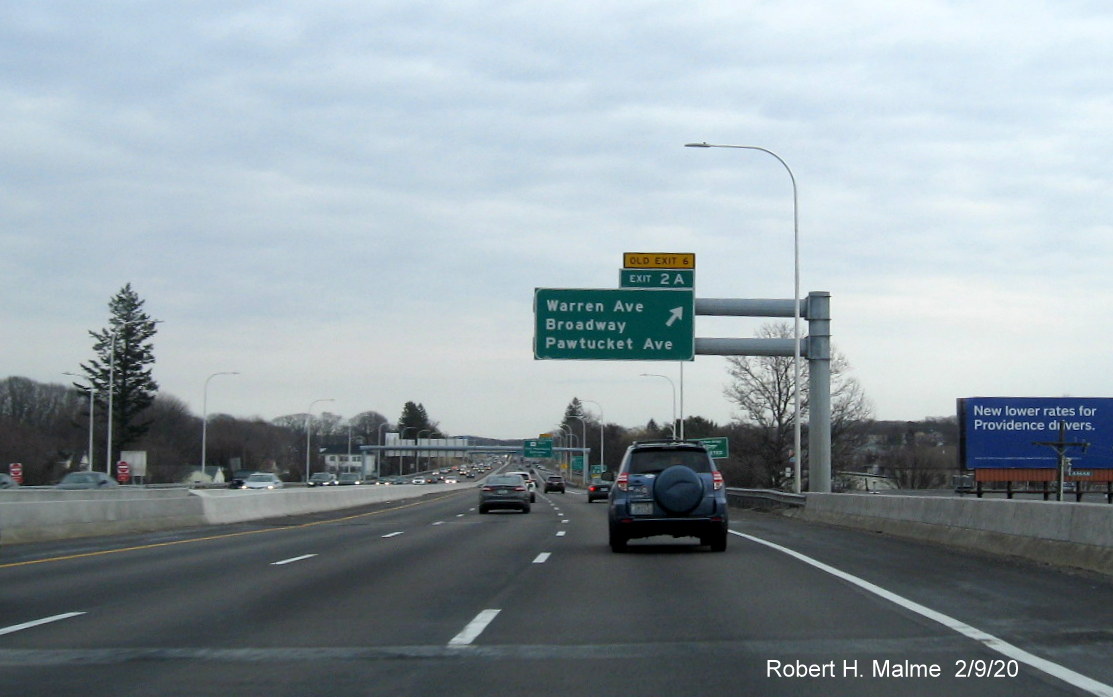 Image of overhead ramp sign with new milepost based number and yellow old exit number tab for Broadway/Pawtucket Avenue exit on I-195 East in East Providence