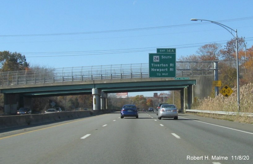 Image of 1/2 mile advance sign for MA 24 South exit with new milepost based exit number and yellow old exit number tab on support post on I-195 West in Fall River, November 2020