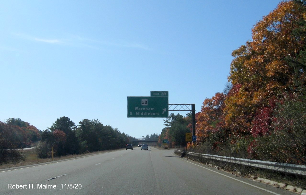 Image of overhead exit sign for MA 28 with new milepost based exit number on I-195 West in Wareham