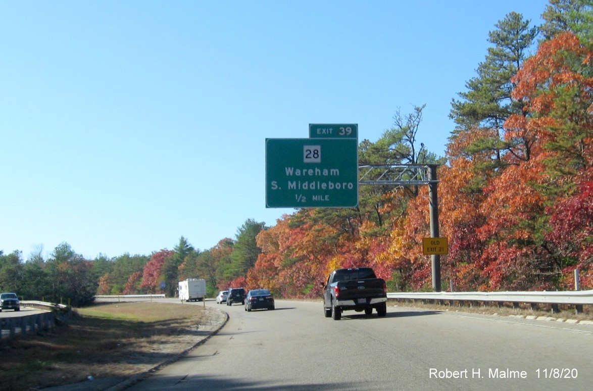 Image of 1/2 mile advance sign with new milepost based exit number and yellow old exit number tab for MA 28 exit on I-195 West in Wareham, November 2020