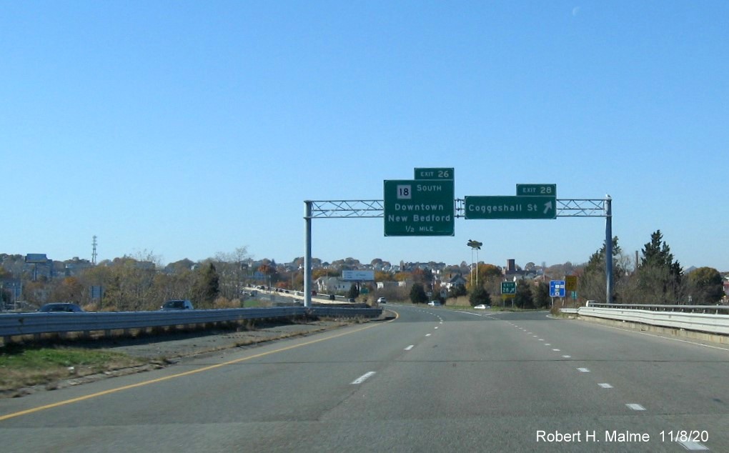 Image of overhead signage for MA 18 and Coggeshall Road with new milepost based exit numbers on I-195 West in New Bedford, November 2020