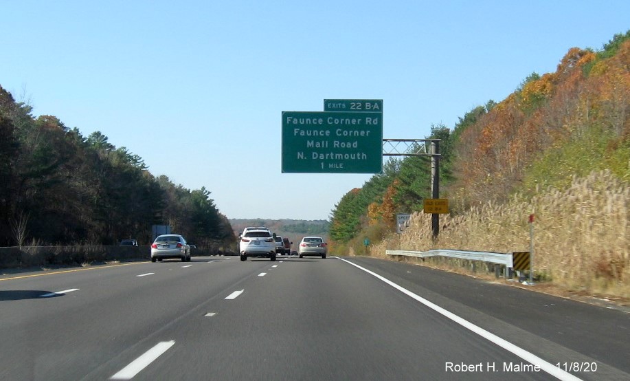Image of 1-Mile advance sign for Faunce Corner and Faunce Corner Mall Roads exits with new milepost based exit numbers and old exit numbers sign on support post on I-195 West in North Dartmouth, November 2020