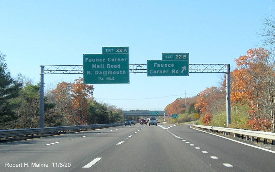Image of overhead signs at ramp to Faunce Corner Road with new milepost based exit numbers and gore sign with new exit number and old exit number tab below on I-195 West in North Dartmouth, November 2020