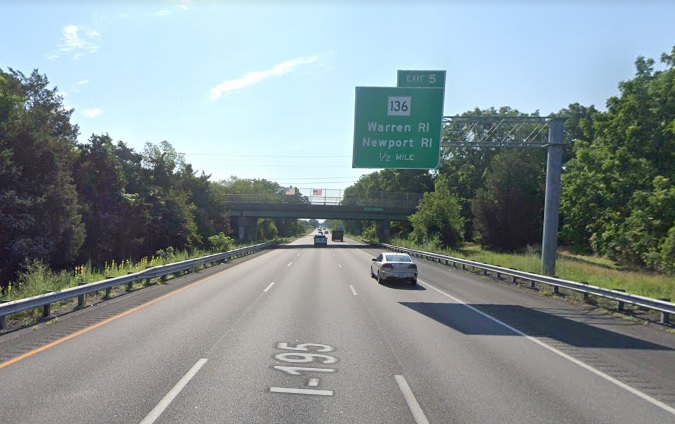 Google Maps Street View image of 1/2 mile advance overhead sign for MA 136 exit with new milepost based exit number on I-195 East in Somerset, July 2021