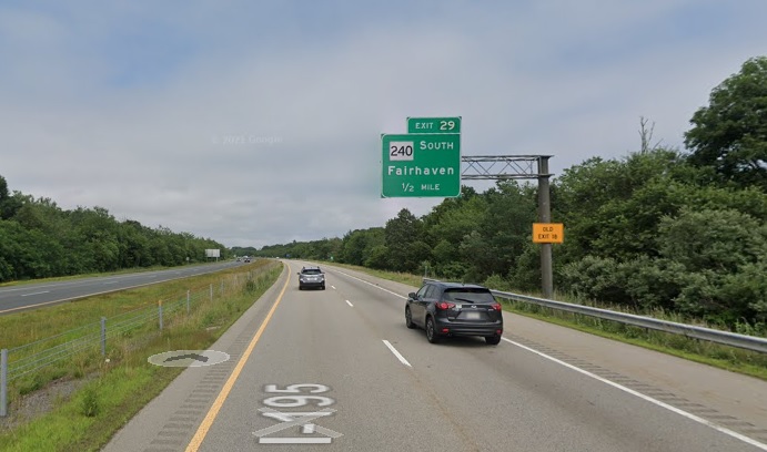 Google Maps Street View image of 1/2 mile advance overhead sign for MA 240 South exit with new milepost based exit number and yellow Old Exit 18 advisory sign on support on I-195 East in Fairhaven, July 2021