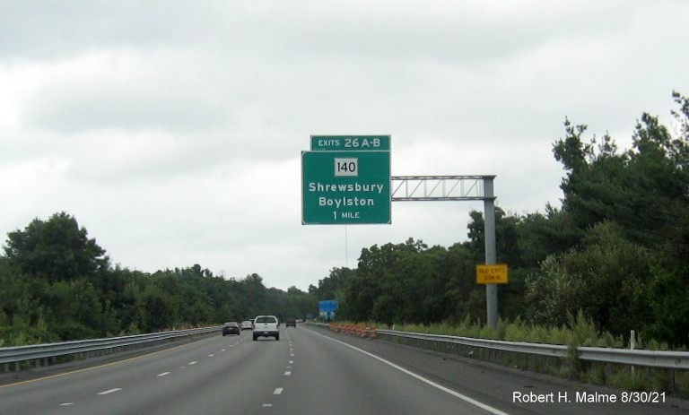 Image of 1 mile advance overhead sign for MA 140 exits with new I-395 milepost based exit numbers and yellow Old Exits 23 A-B advisory sign on support on I-290 East in Shrewsbury, August 2021