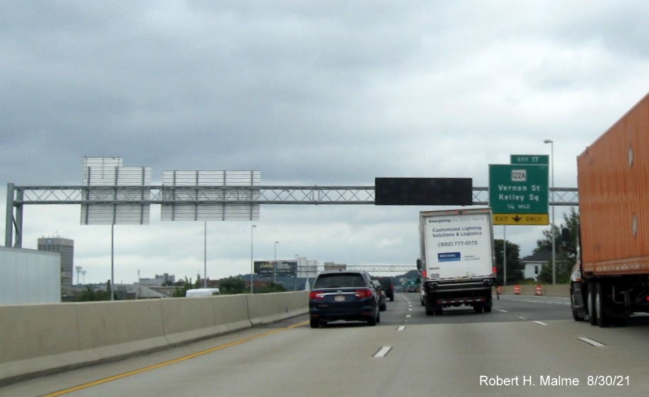 Image of recently placed 1/4 mile advance overhead sign for MA 122A / Kelley Square exit with new I-395 milepost based exit number on I-290 East in Worcester, August 2021