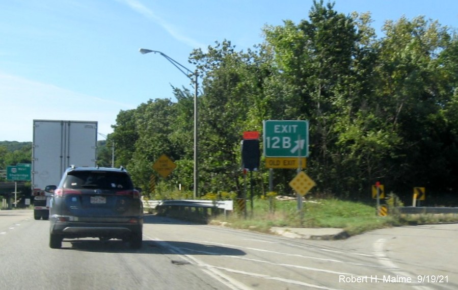 Image of newly placed gore sign for To MA 12 South exit with new milepost based exit number and yellow Old Exit 8 sign attached below on I-290 West in Auburn, September 2021
