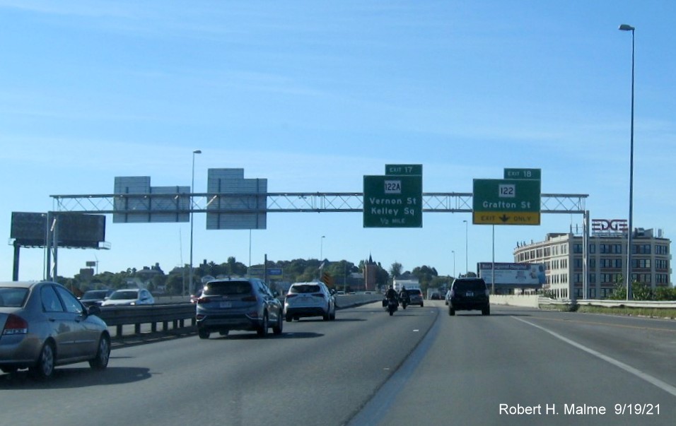 Image of overhead signs at ramp for MA 122 exit with new milepost based exit numbers on I-290 West in Worcester, September 2021