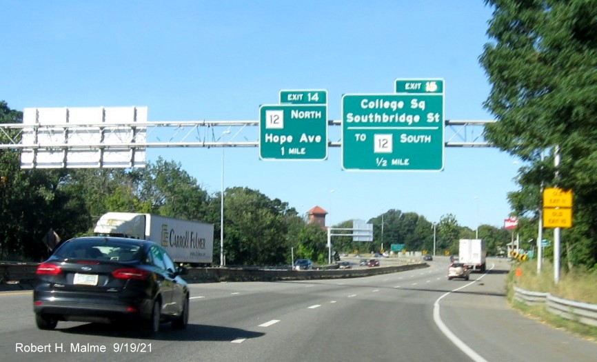 Image of overhead advance signs for MA 12 North and College Square exit with new milepost based exit numbersand yellow Old Exit 11 and 10 advisory signs on right support on I-290 West in Worcester, September 2021