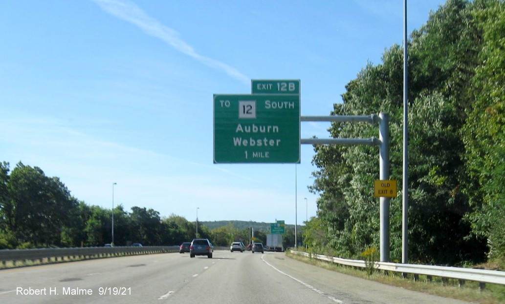 Image of newly placed 1 mile advance overhead sign for To MA 12 South exit with new milepost based exit number and yellow Old Exit 8 advisory sign on support on I-290 West in Auburn, September 2021