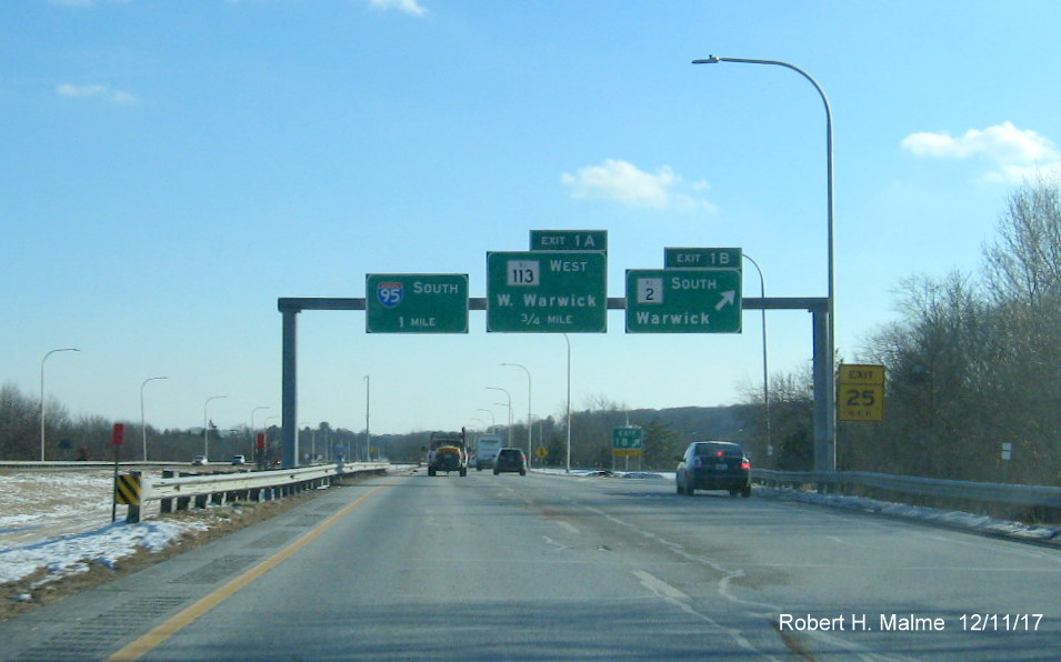 Image of overhead signs for RI 2 and RI 113 exits on I-295 South in Warwick with new exit numbers