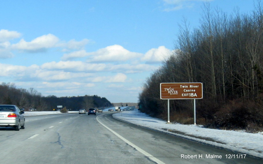 Image of brown attractions guide sign with new exit number prior to RI 146 exit on I-295 North in Lincoln
