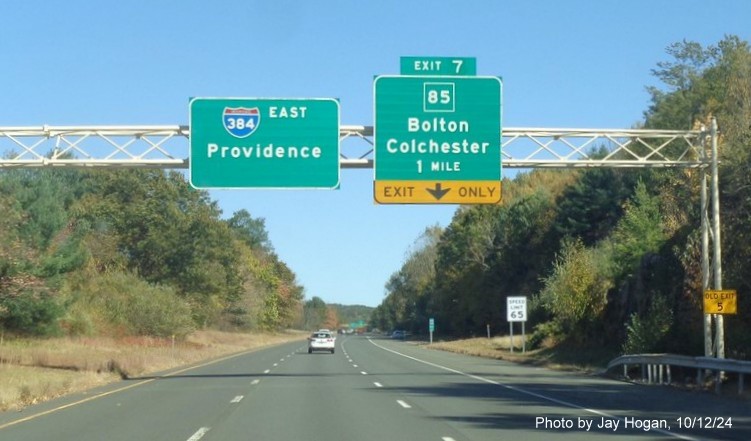 Image of 1 mile advance overhead sign for CT 85 exit with new milepost based ext number and yellow 
      Old Exit 5 sign on support post, by Jay Hogan, October 2024