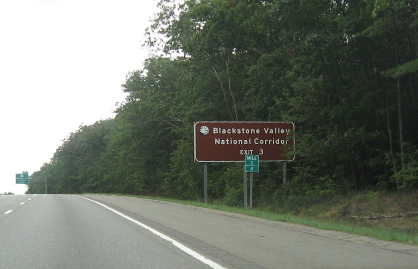 Image of brown ground mounted auxiliary sign for MA 16 exit with new milepost based exit number on I-395 South in Webster, August 2021 with 
