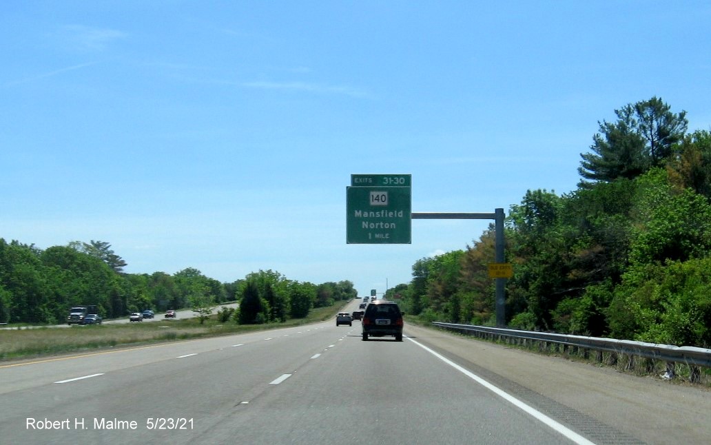 Image of 1 mile advance overhead sign for MA 140 exits with new milepost based exit numbers and yellow Old Exits 12-11 advisory sign on support on I-495 South in Mansfield, May 2021