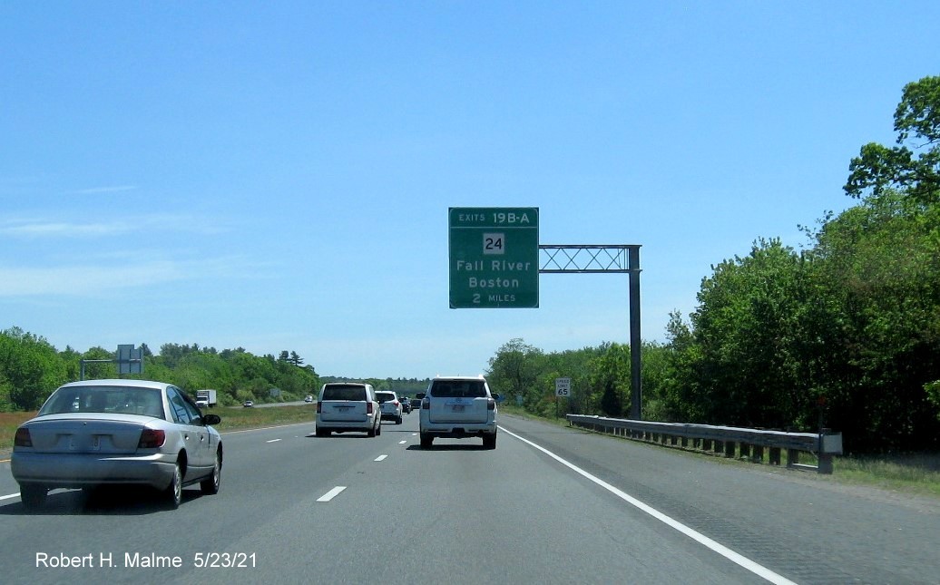 Image of 2 miles advance overhead sign for MA 24 exits with new milepost based exit numbers on I-495 South in Raynham, May 2021