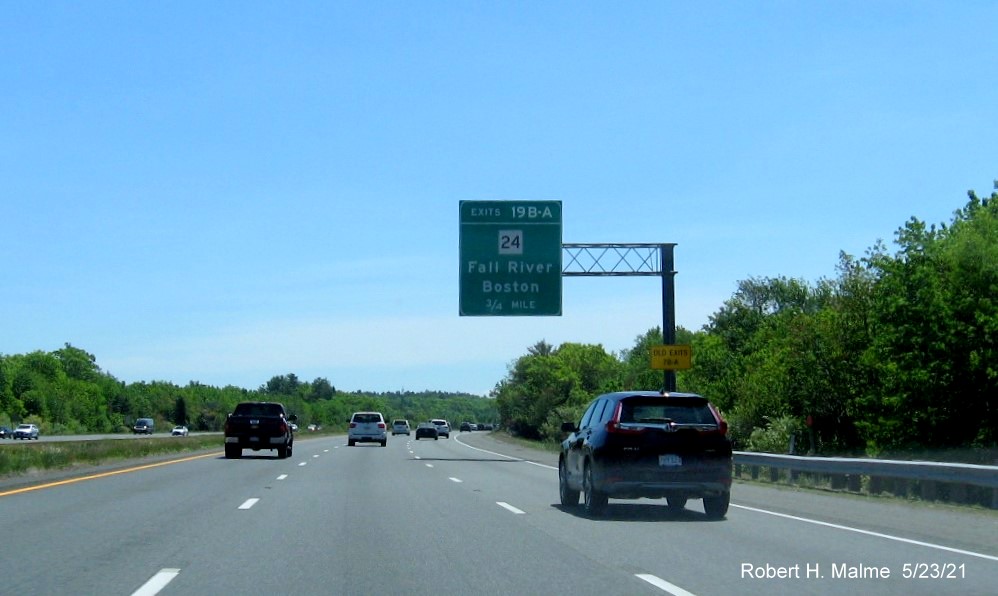 Image of 1 mile advance overhead sign for MA 24 exits with new milepost based exit numbers and yellow Old Exits 7 B-A advisory sign on support on I-495 South in Raynham, May 2021