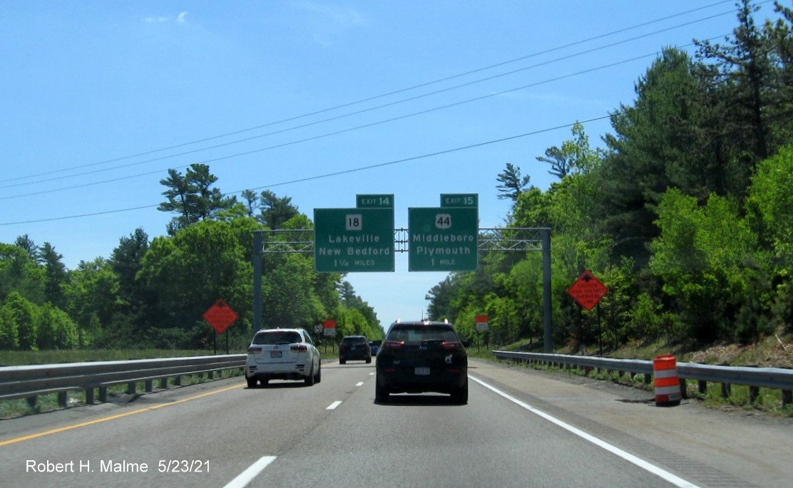 Image of overhead advance signs for MA 18 and US 44 exits with new milepost based exit numbers on I-495 South in Middleboro, May 2021