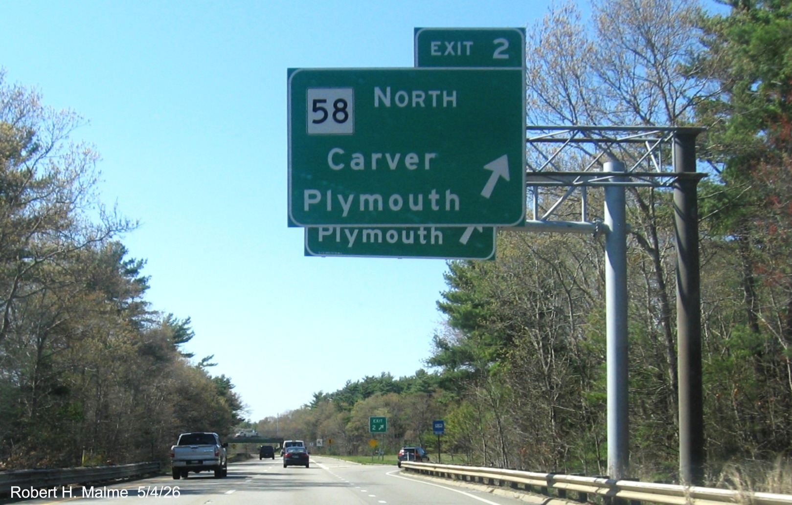 Image of new overhead ramp sign for MA 58 exit on I-495 North in Wareham, obscured by the
	existing sign not yet taken down, Google Maps Street View, May 2026