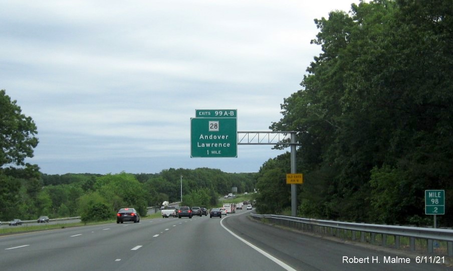 Image of 1 Mile advance overhead sign for MA 28 exits with new milepost based exit numbers and yellow Old Exits 41 A-B advisory sign on support on I-495 North in Andover, June 2021