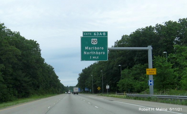Image of 1 mile advance overhead sign for US 20 exits with new milepost based exit numbers and yellow Old Exits 24 A-B advisory sign on support on I-495 North in Marlborough, June 2021