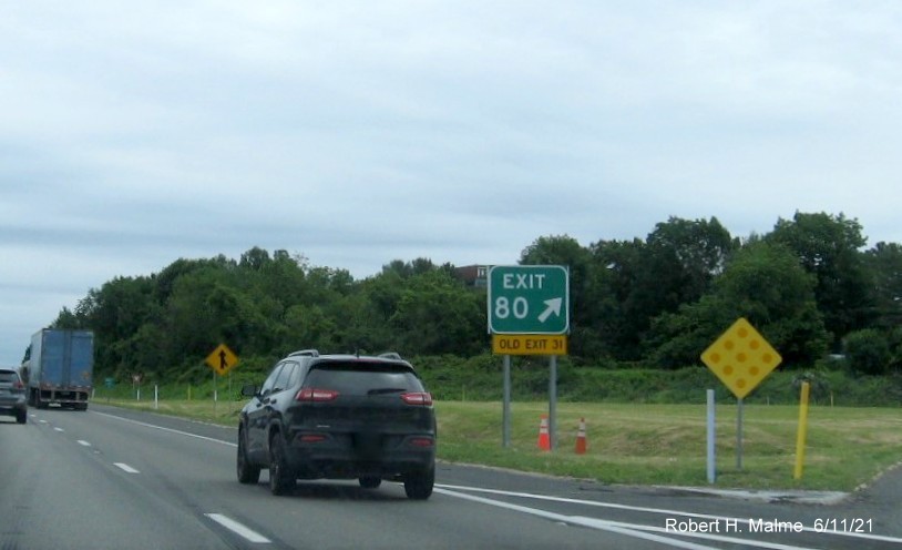 Image of gore sign for MA 119 exit with new milepost based exit number and yellow Old Exit 31 sign attached below on I-495 North in Littleton, June 2021