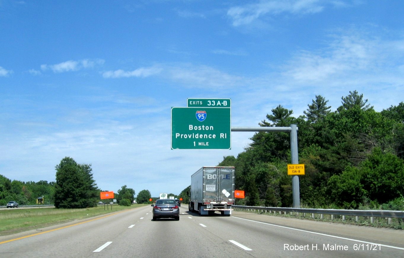 Image of 1 mile advance overhead sign for I-95 exit with new milepost based exit numbers and yellow Old Exits 13 A-B advisory signs on support on I-495 North in Mansfield, June 2021