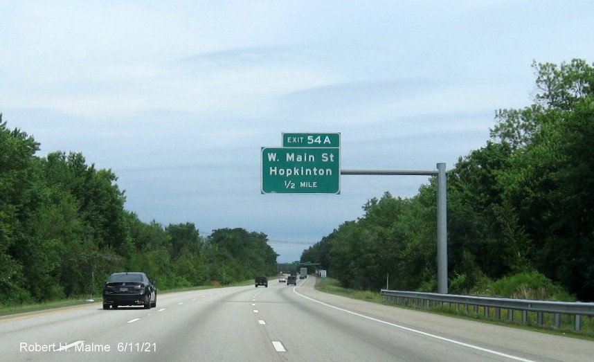 Image of 1/2 mile advance overhead sign for West Main Street east exit with new milepost based exit number on I-495 North in Hopkinton, June 2021