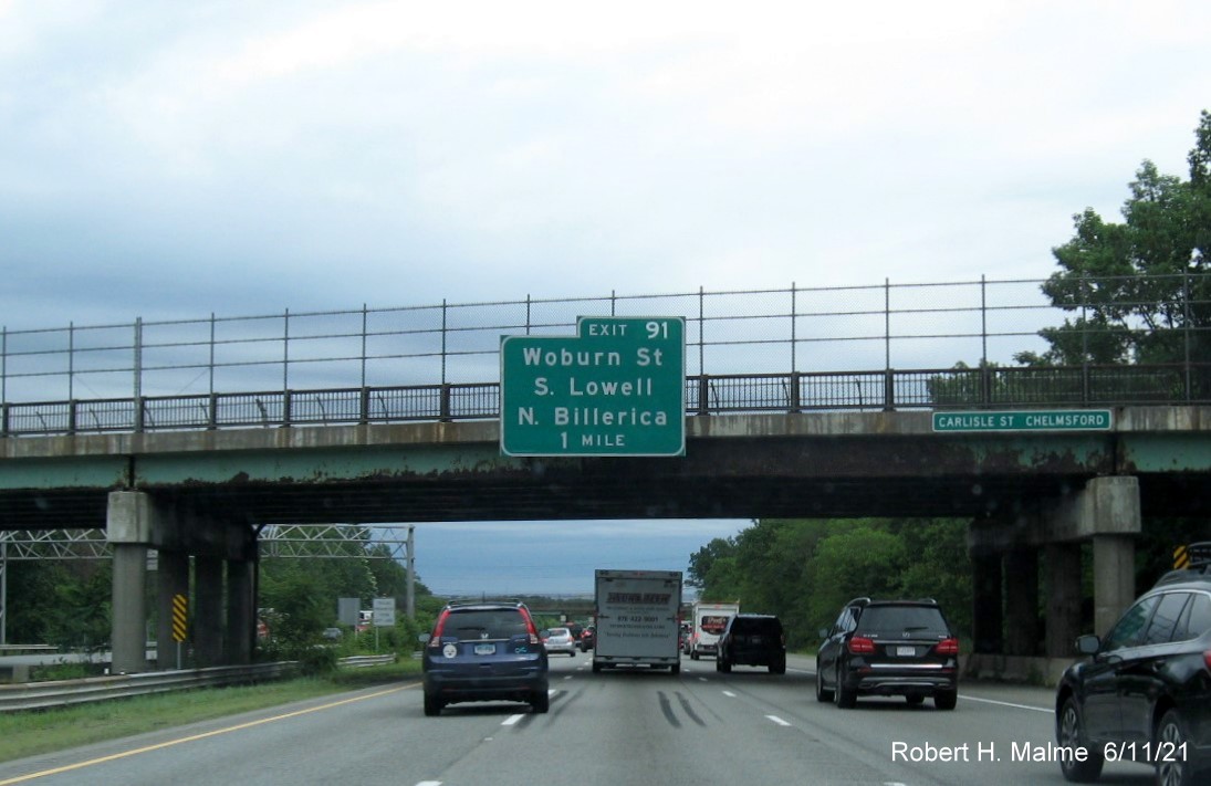 Image of 1 mile advance bridge mounted sign for Woburn Street exit with new milepost based exit number on I-495 North in Chelmsford, June 2021