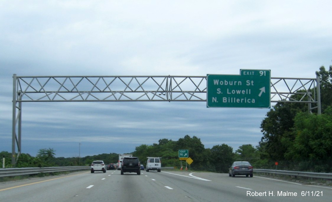 Image of overhead ramp sign for Woburn Street exit with new milepost based exit number on I-495 North in Chelmsford, June 2021