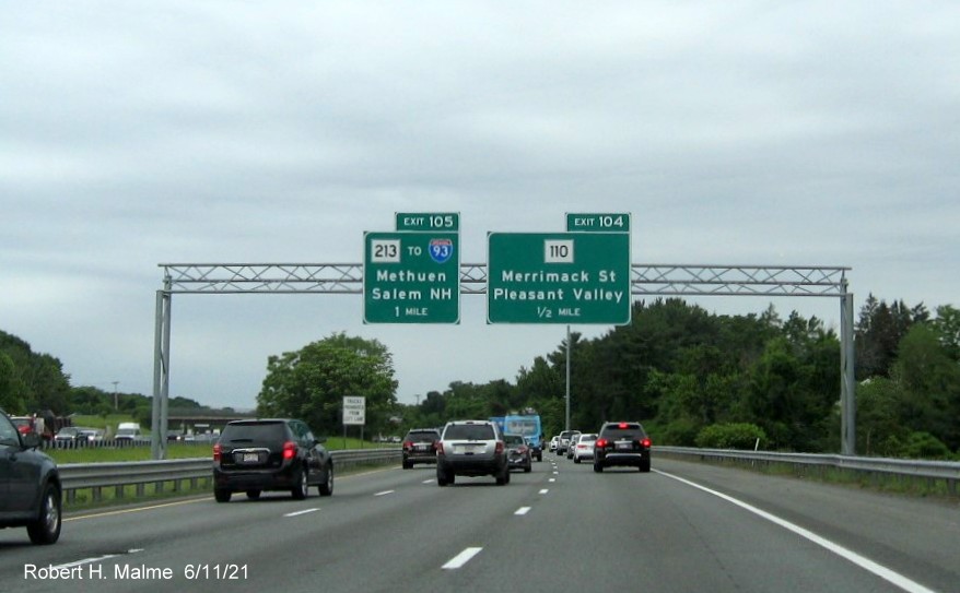 Image of overhead advance signage for MA 213 and MA 110 exits with new milepost based exit numbers on I-495 North in Lawrence, June 2021
