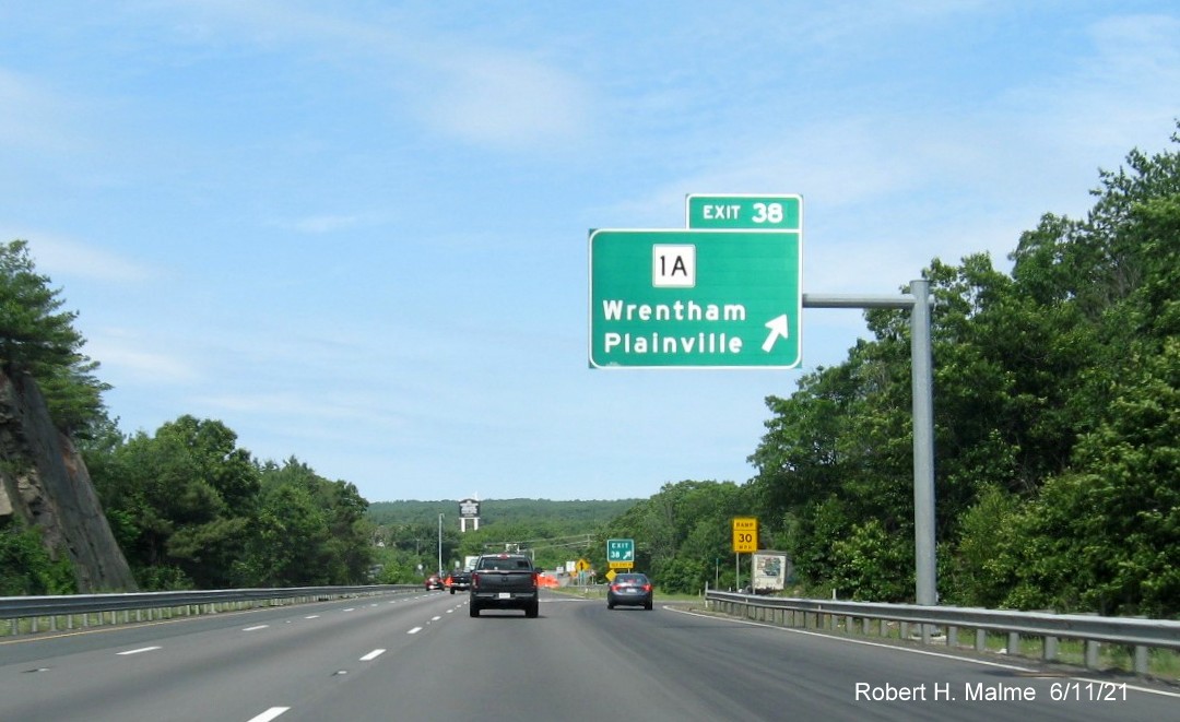 Image of overhead ramp sign for MA 1A exit with new milepost based exit number on I-495 North in Wrentham, June 2021