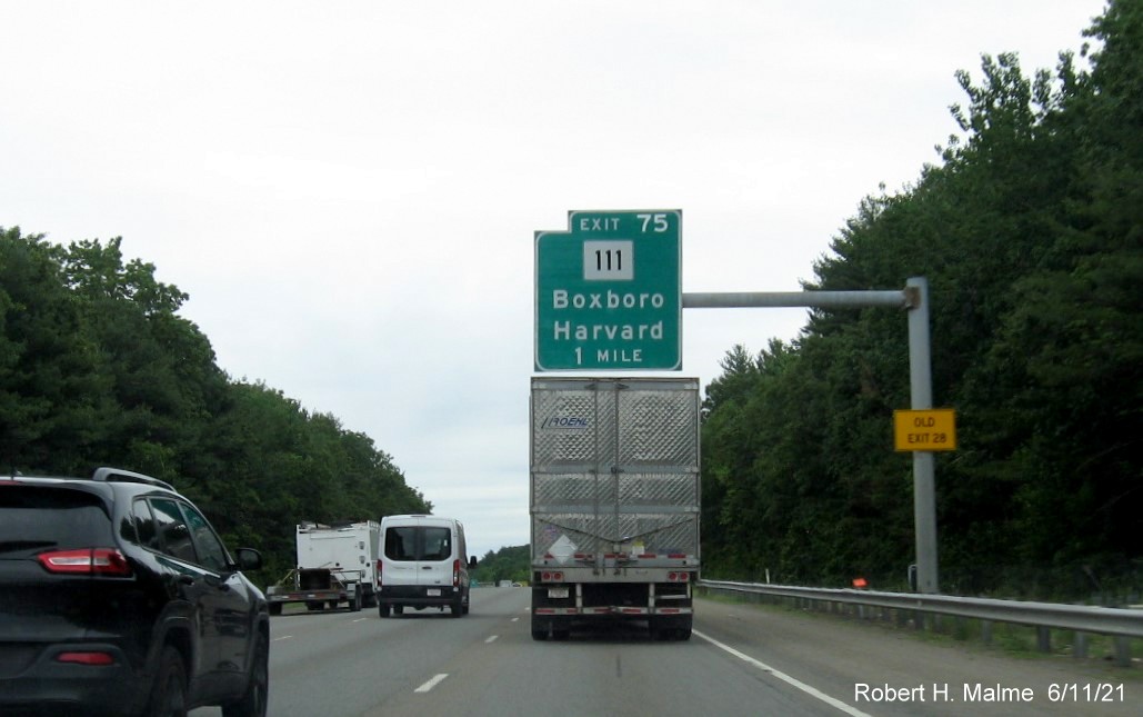 Image of 1 mile advance overhead sign for MA 111 exit with new milepost based exit number and yellow Old Exit 28 advisory sign on support on I-495 North in Harvard, June 2021