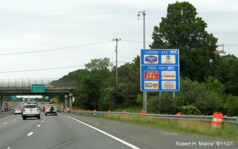 Image of blue Lodging Services sign for MA 110/113 exit with new milepost based exit number on I-495 North in Lawrence, June 2021