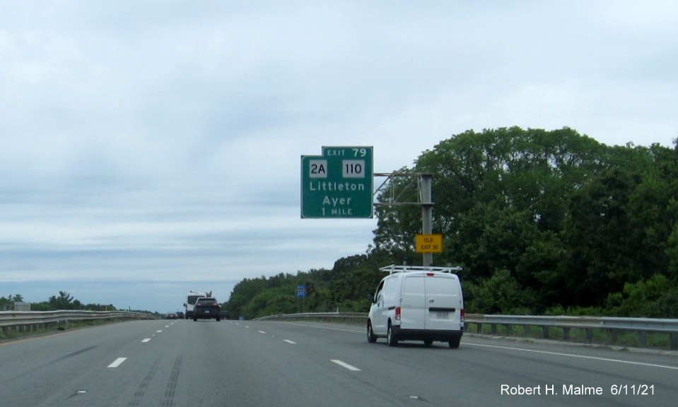 Image of 1 Mile advance overhead sign for MA 2A/110 exit with new milepost based exit number and yellow Old Exit 30 advisory sign on support on I-495 North in Littleton, June 2021