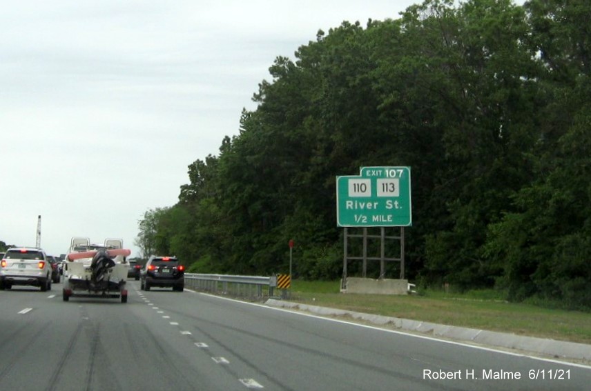 Image of 1/2 mile temporary sign for MA 110/113 exit with new milepost based exit number on I-495 North in Lawrence, June 2021