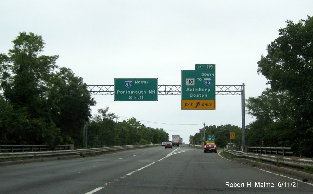 Image of overhead ramp sign for MA 110 exit with new milepost based exit number on I-495 North in Amesbury, June 2021