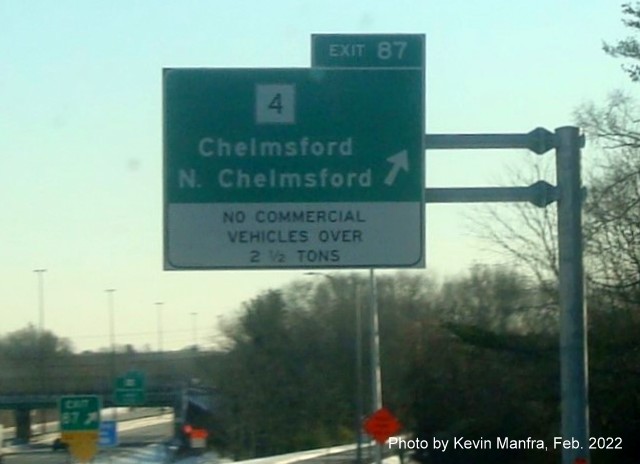 Image of recently placed overhead ramp sign for MA 4 exit with white Truck Restriction tab on bottom on I-495 North in Chelmsford, by Kevin Manfra, February 2022