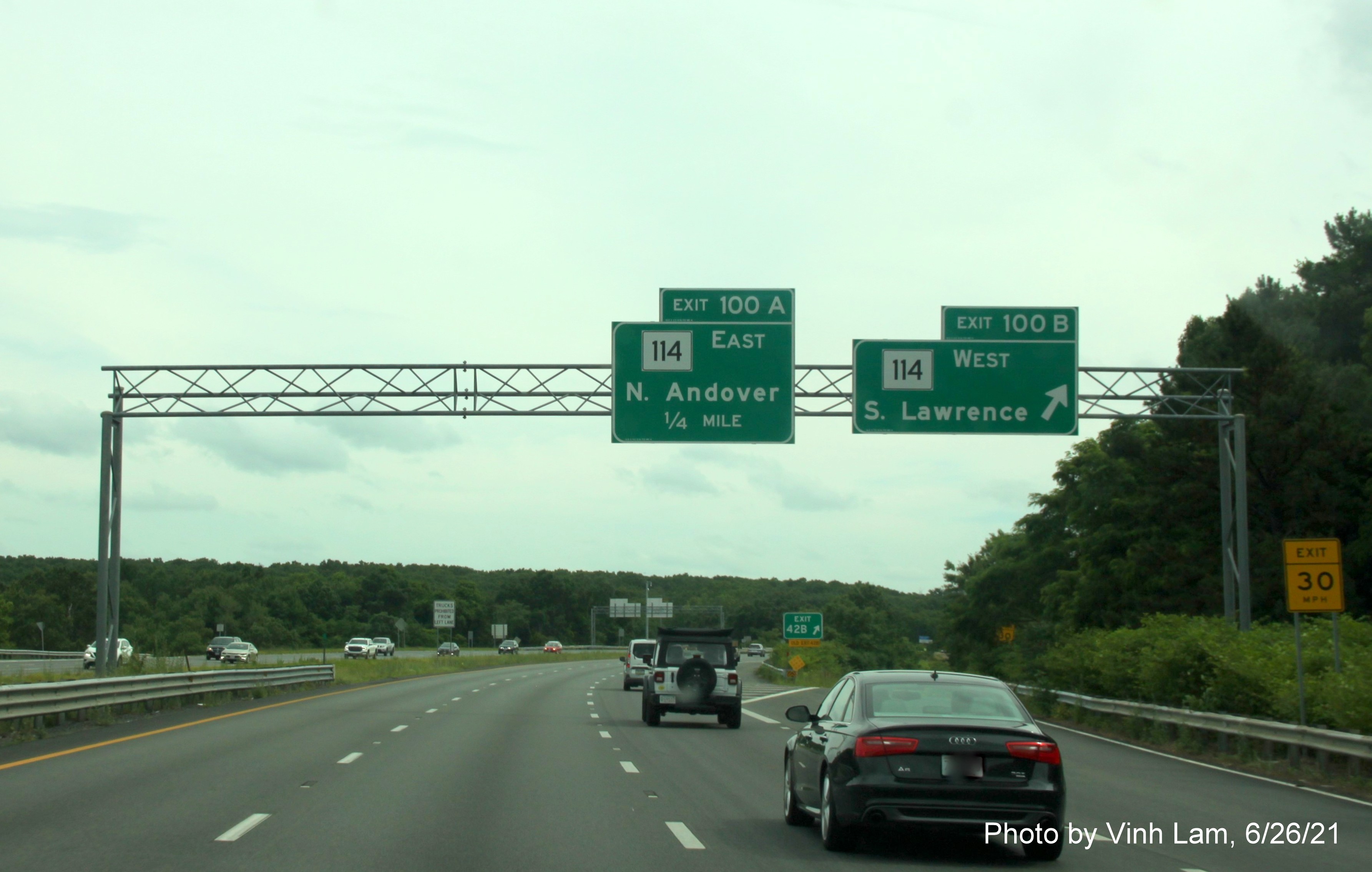 Image of overhead signage at ramp for MA 114 West exit with new milepost exit numbers on I-495 South in North Andover, by Vinh Lam, June 2021