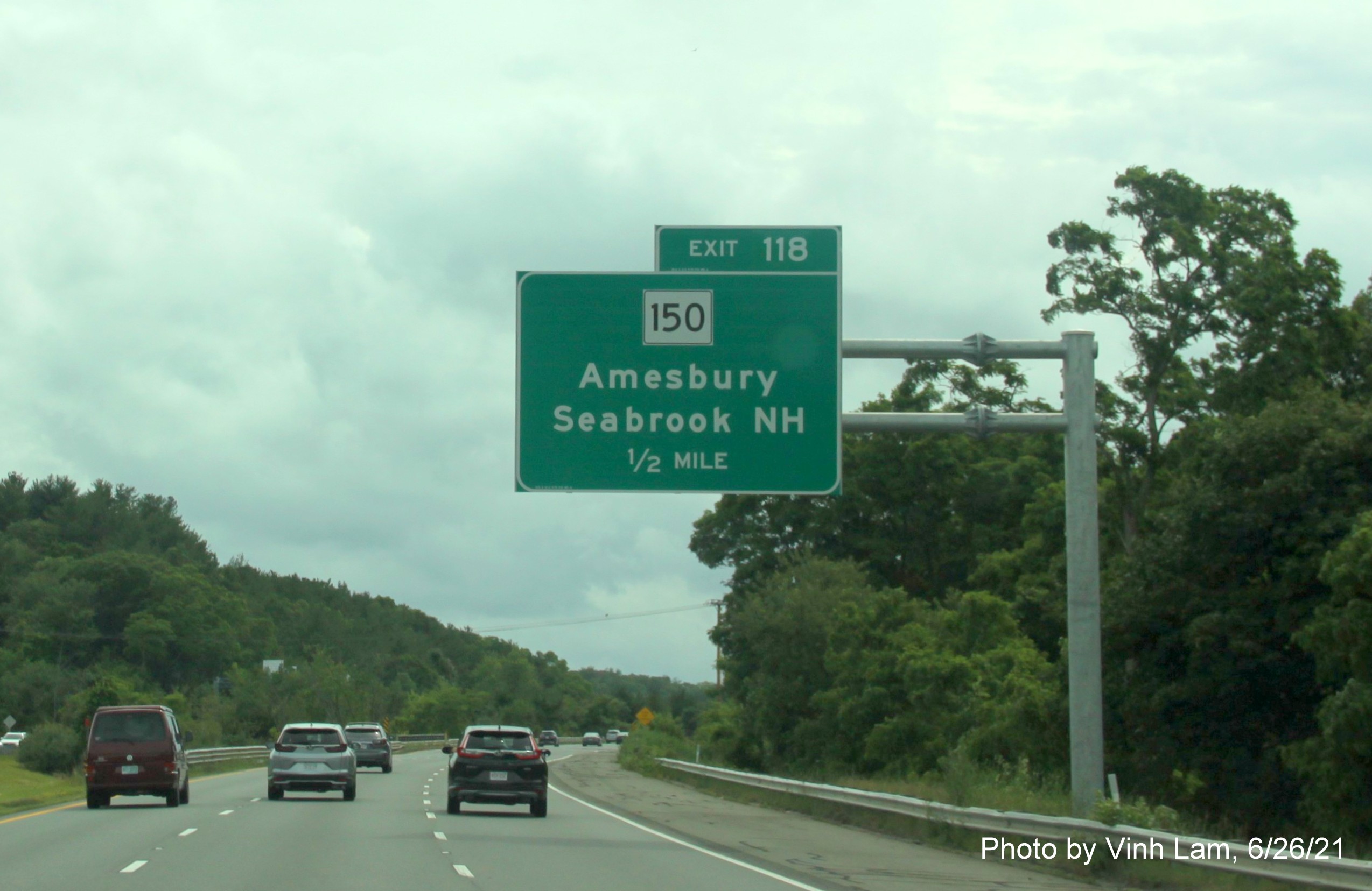 Image of 1/2 mile advance overhead sign for MA 150 exit with new milepost based exit number on I-495 South in Amesbury, photo bt Vinh Lam, June 2021