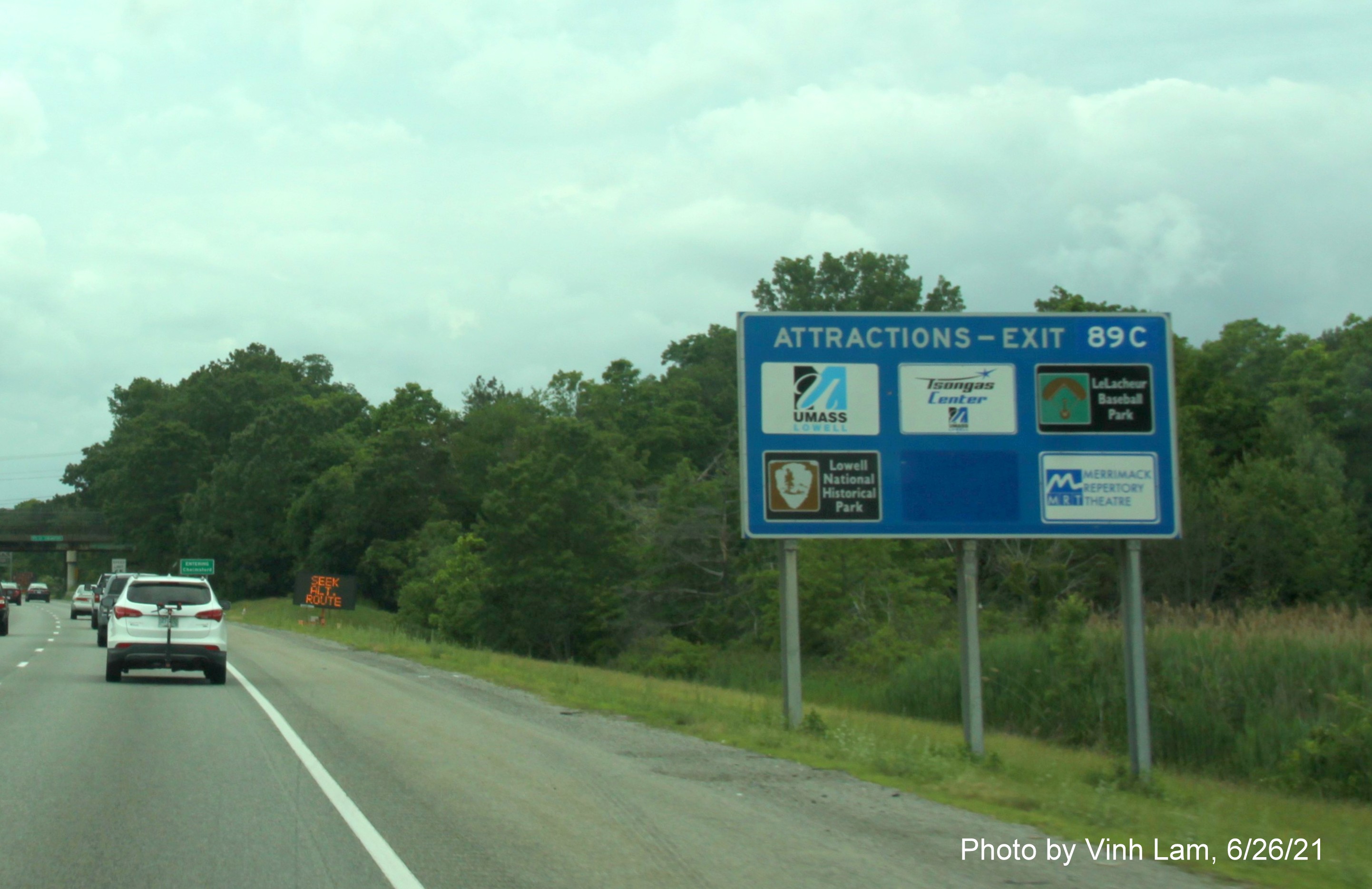 Image of blue Attractions Services sign for Lowell Connector exit with new milepost based exit number on I-495 South in Chelmsford, June 2021