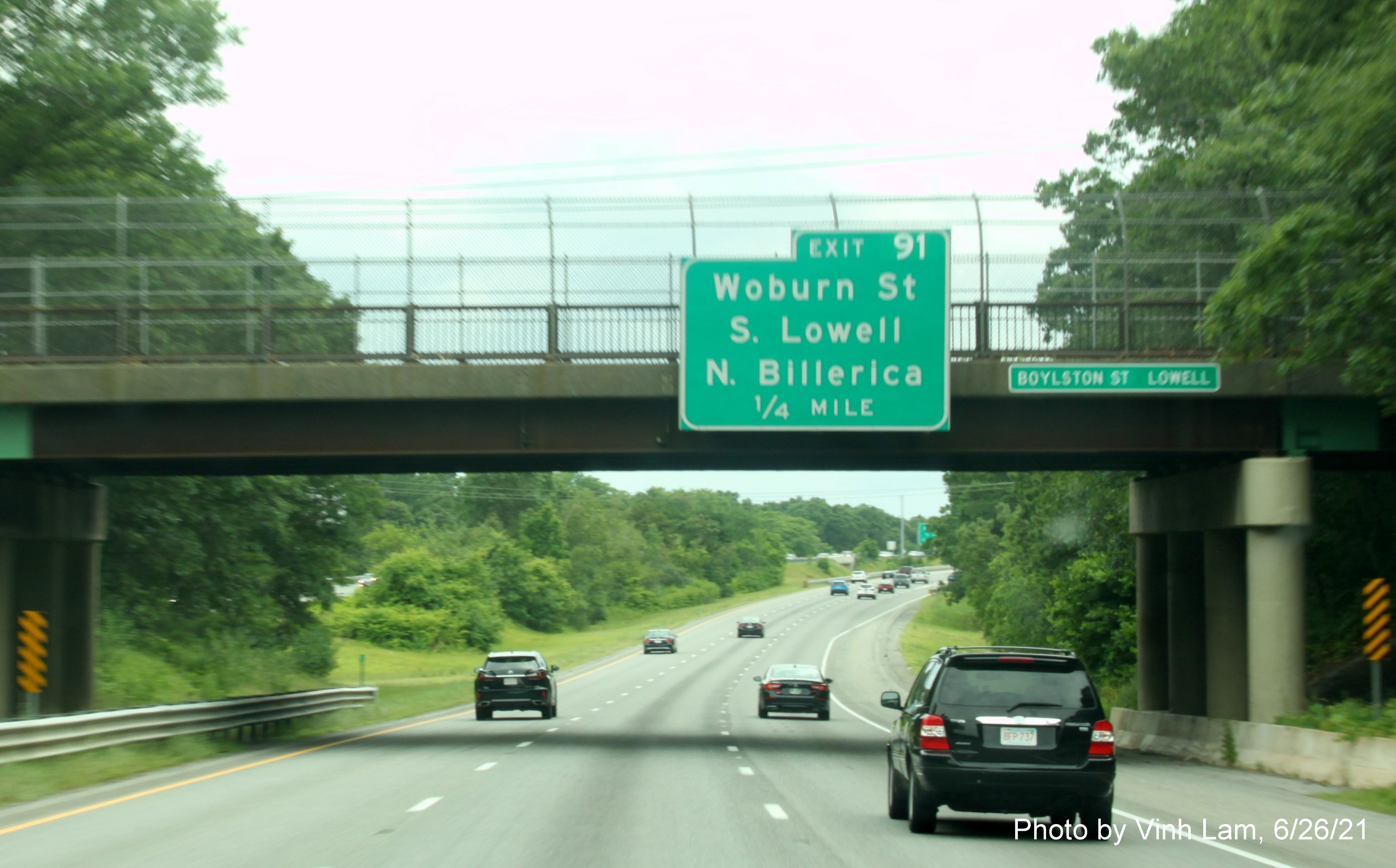 Image of 1/4 Mile advance bridge mounted sign for Woburn Street exit with new milepost based exit number on I-495 South in Lowell, by Vinh Lam, June 2021