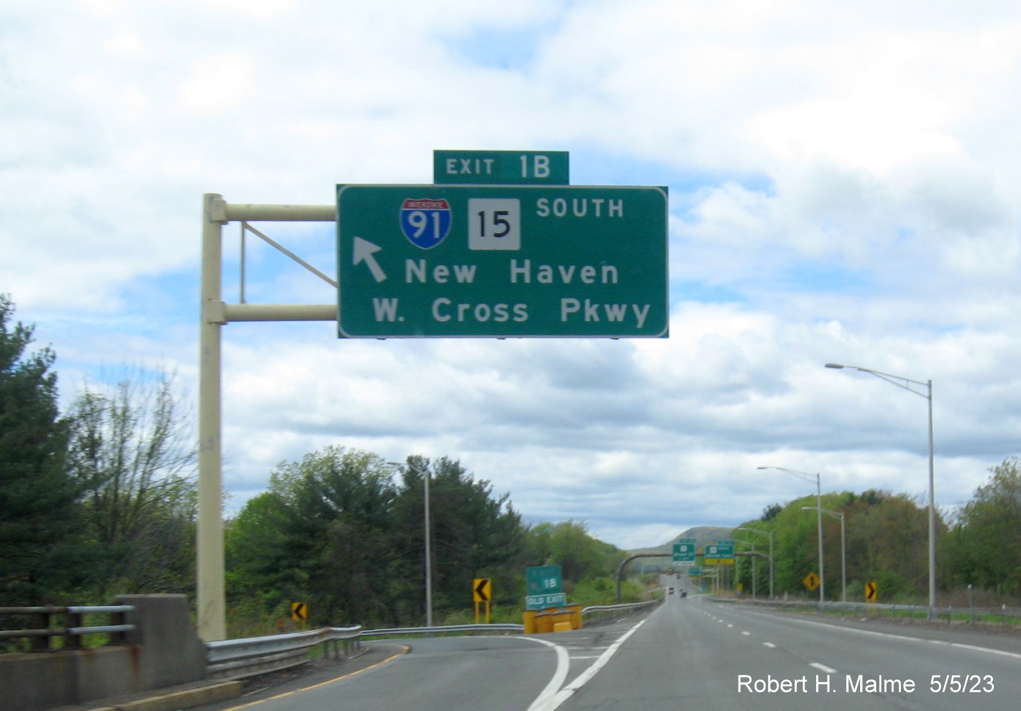 Image of overhead ramp sign for I-91/CT 15 South exit with new milepost based exit number on I-691 West in Meriden CT, May 2023