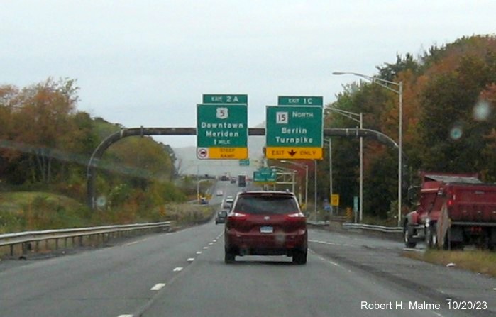 Image of new overhead signs for the US 5 and CT 15 South exits with new milepost based exit numbers 
         on I-691 West in Meriden, October 2023