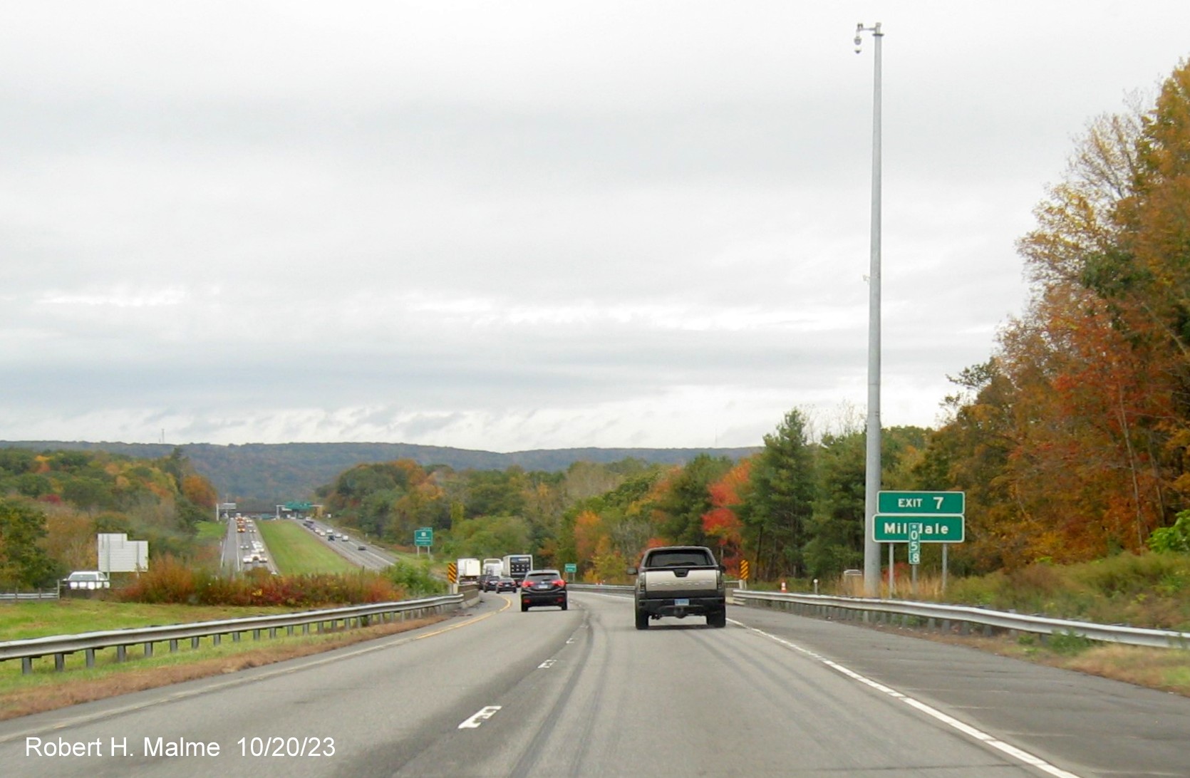 Image of new auxiliary sign for the CT 10 exit with new mile marker with 3 digit number in front
         on I-691 West in Cheshire, October 2023