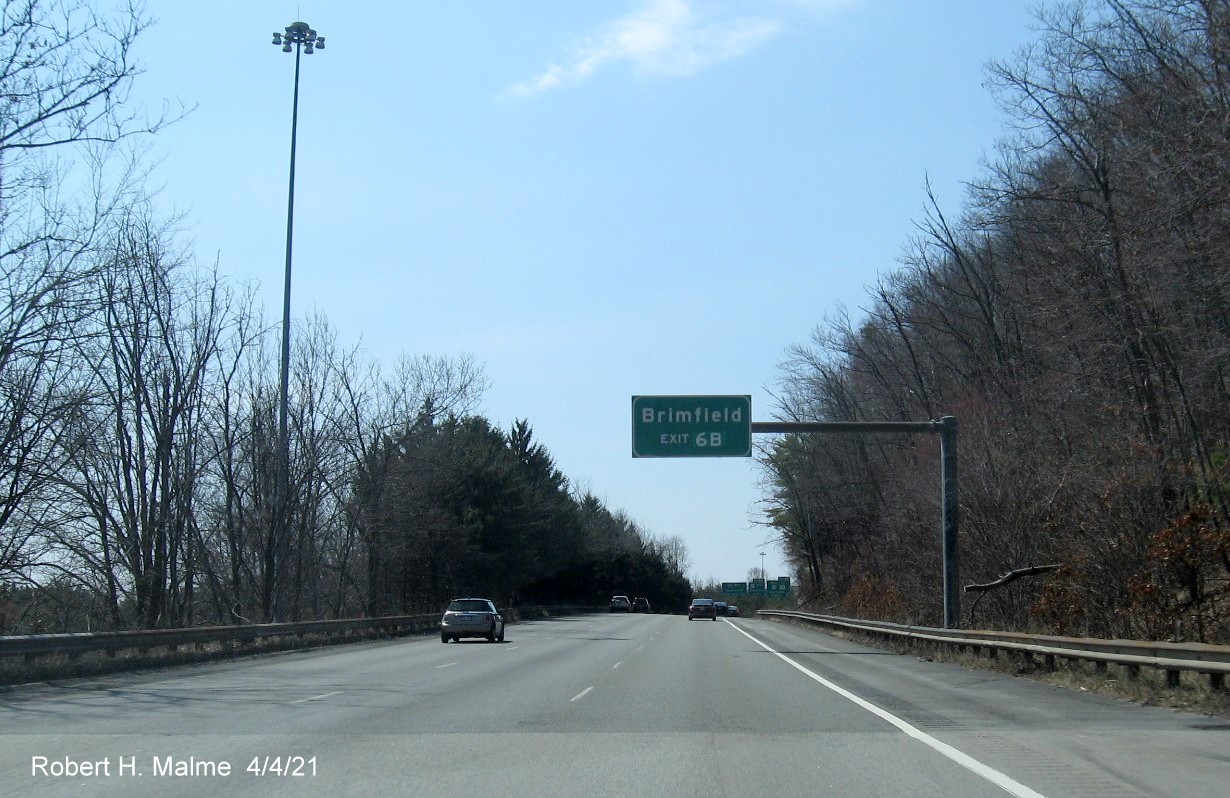 Image of overhead auxiliary sign for US 20 West exit with new milepost based exit number on I-84 West in Sturbridge, April 2021