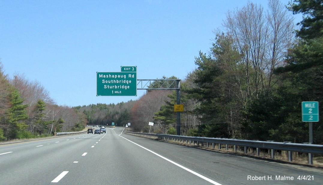 Image of 1 Mile advance overhead sign for Mashapaug Road exit with new milepost based exit number and yellow Old Exit 1 advisory sign on right support on I-84 East in Sturbridge, April 2021